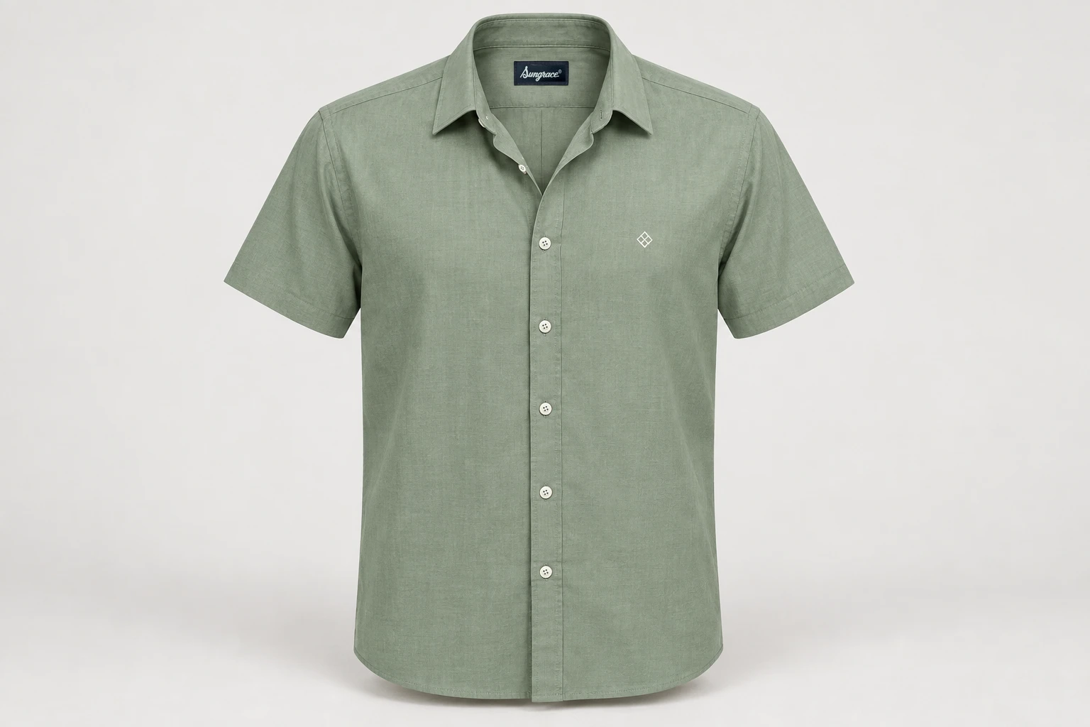 Corporate Shirts — Muted sage green men's short-sleeve shirt, clean point collar, straight hem, no pocket, small original white geometric chest embroidery. product front. Illustrative catalogue concept.