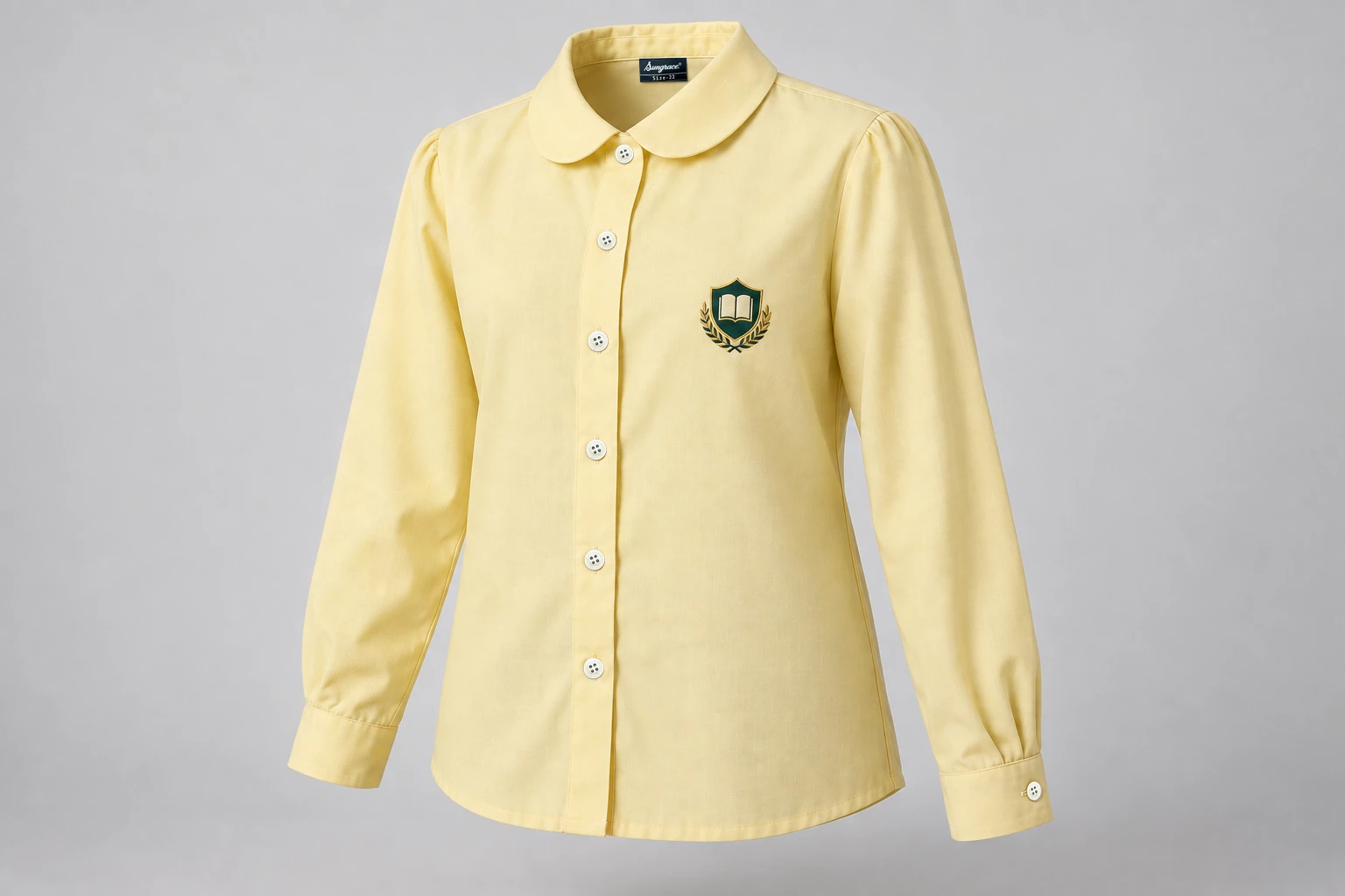 Full-Sleeve School Blouses — soft pale yellow with rounded collar and sample crest. front three-quarter product photograph. Illustrative catalogue concept.