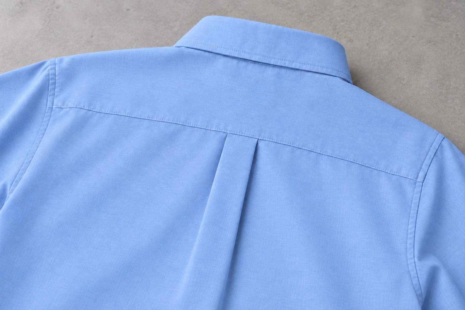 Full-Sleeve School Shirts — Sky-blue classic back yoke, collar stand and box pleat. close rear yoke construction detail photograph. Illustrative catalogue concept.