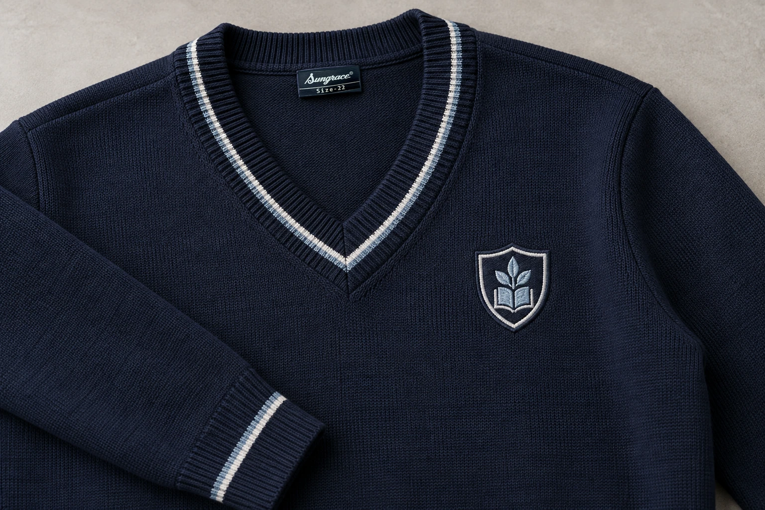 Full-Sleeve School Sweaters — Navy with fine silver-grey rib stripe. detail. Illustrative catalogue concept.