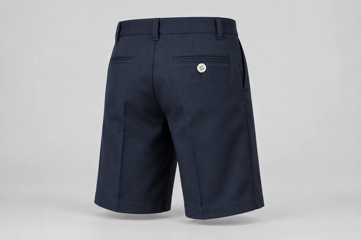 School Shorts — Navy longer-length short. rear three-quarter product photograph. Illustrative catalogue concept.