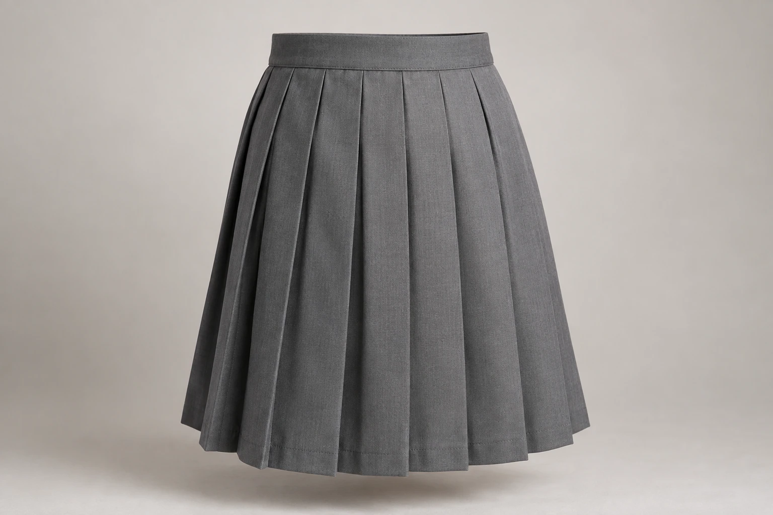 School Skirts — Grey knife pleat. front three-quarter product photograph. Illustrative catalogue concept.