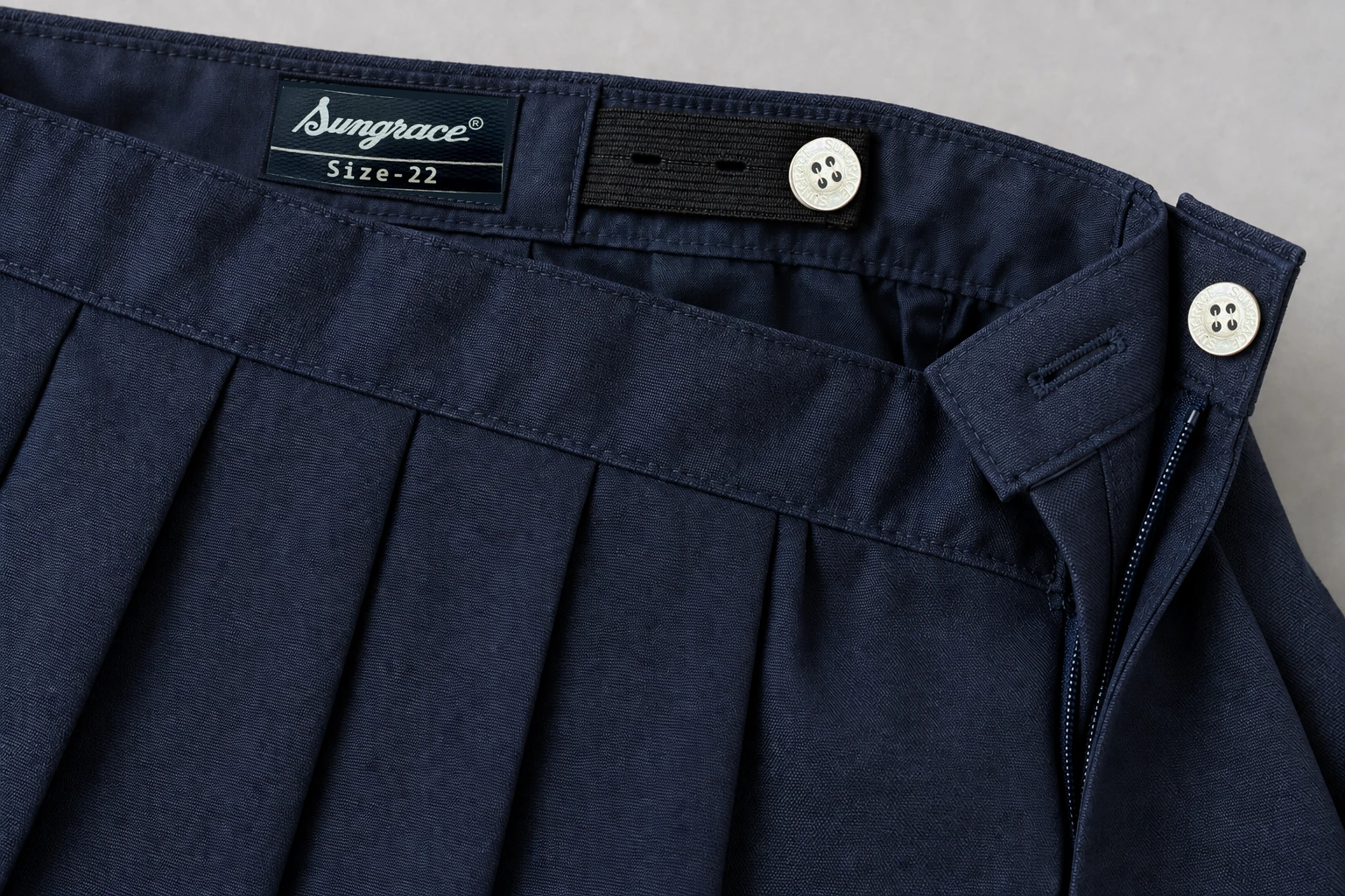 School Skirts — Navy box pleat waistband. macro waistband construction detail photograph. Illustrative catalogue concept.