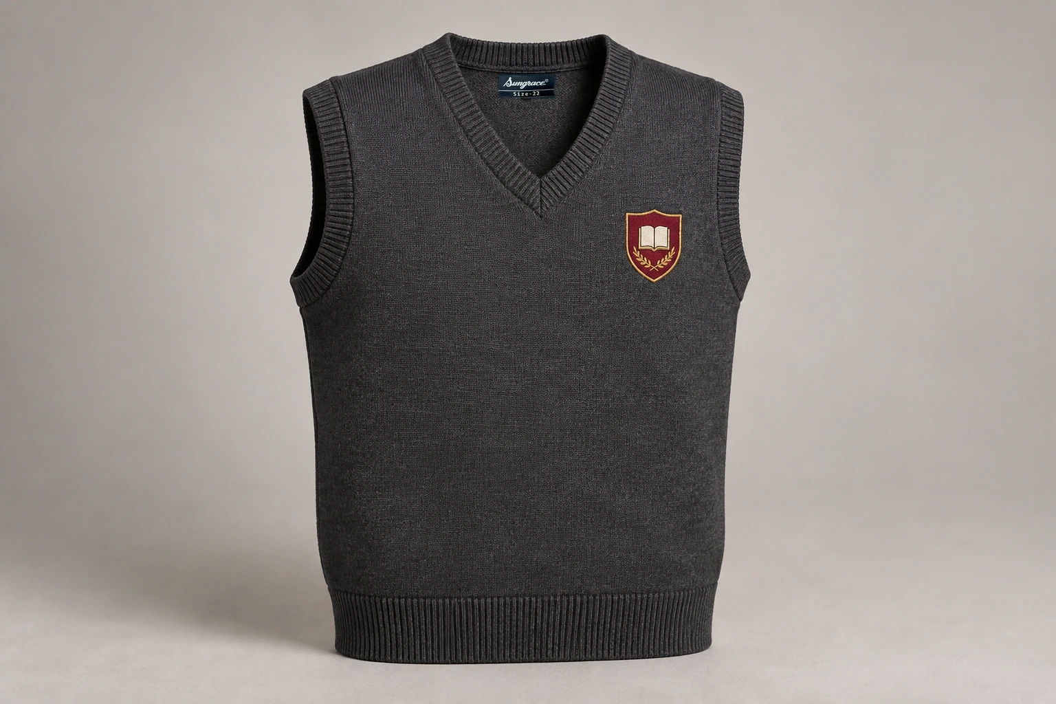 Sleeveless School Sweaters — Charcoal with sample crest. product. Illustrative catalogue concept.