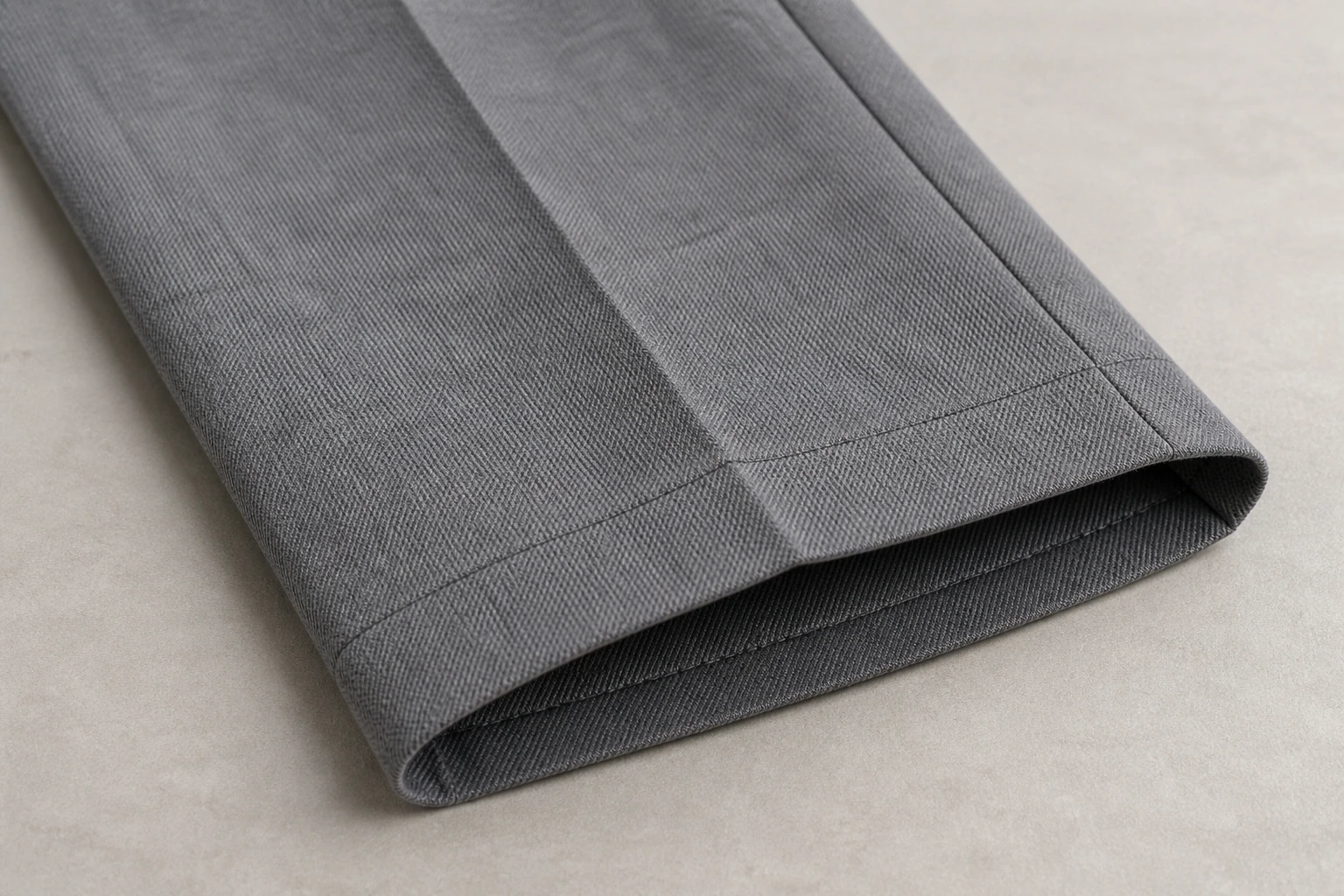 School Trousers — Grey trouser twill, crease and hem construction. detail macro. Illustrative catalogue concept.