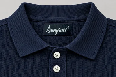 Corporate Polo Shirts — Navy pique collar, inside label and two-button placket. detail macro. Illustrative catalogue concept.
