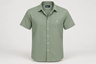 Corporate Shirts — Muted sage green men's short-sleeve shirt, clean point collar, straight hem, no pocket, small original white geometric chest embroidery. product front. Illustrative catalogue concept.