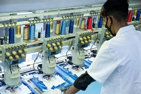 Sungrace factory operator working on garment embroidery
