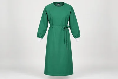 OT and Procedure Gowns — Unisex green calf-length reusable cloth procedure-gown concept, long raglan sleeves, white knit cuffs, round neck and waist ties. product front. Illustrative catalogue concept.