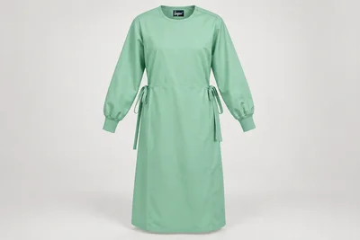 OT and Procedure Gowns — Unisex mint-green calf-length cloth procedure-gown concept with long sleeves and narrow fabric cuffs, waist ties. product front. Illustrative catalogue concept.