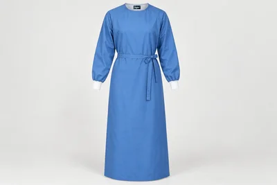 OT and Procedure Gowns — Unisex medium-blue ankle-length cloth procedure-gown concept, generous cut, set-in long sleeves and white knit cuffs. product front. Illustrative catalogue concept.