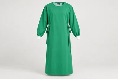 OT and Procedure Gowns — Unisex bright-green generously proportioned calf-length cloth procedure-gown concept, full sleeves and compact white cuffs. product front. Illustrative catalogue concept.