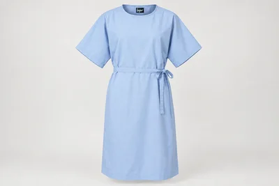 Patient Gowns — Unisex pale-blue knee-length patient gown with wide short sleeves, round neckline and overlapping rear tie closure. product front. Illustrative catalogue concept.