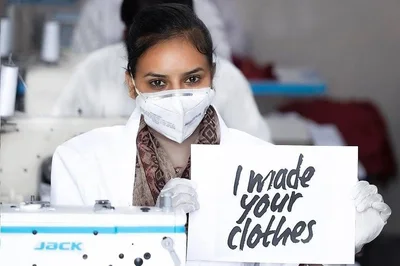 A woman at a sewing machine holding a sign that reads I made your clothes