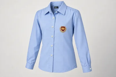 Full-Sleeve School Blouses — powder blue with soft point collar and burgundy sample crest. front three-quarter product photograph. Illustrative catalogue concept.