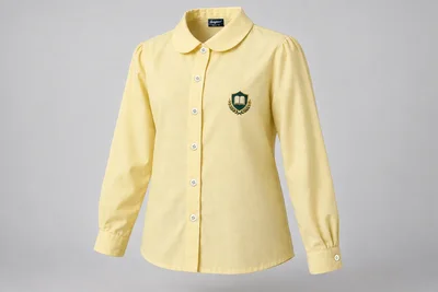 Full-Sleeve School Blouses — soft pale yellow with rounded collar and sample crest. front three-quarter product photograph. Illustrative catalogue concept.