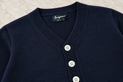 Full-Sleeve School Cardigans — Navy cardigan · neck and button construction. detail. Illustrative catalogue concept.