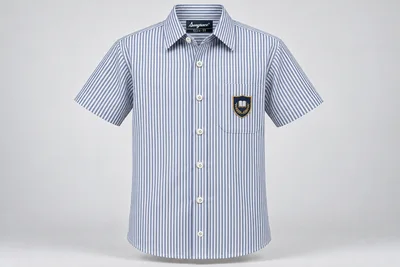 Half-Sleeve School Shirts — white and navy fine vertical stripe with sample crest. front product photograph. Illustrative catalogue concept.