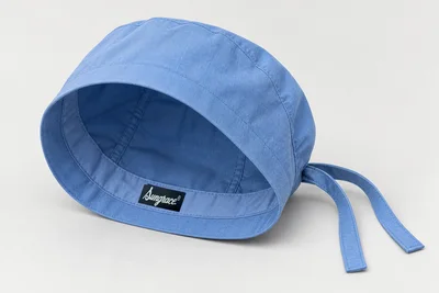 Scrub Caps — Ceil-blue woven scrub cap with fuller rounded crown and tie back. product rear three-quarter. Illustrative catalogue concept.