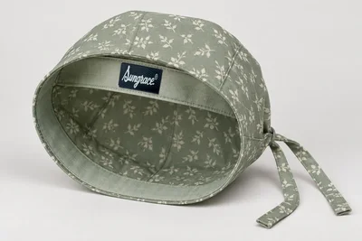 Scrub Caps — Sage woven scrub cap with tiny original cream leaf print and tie back. product rear three-quarter. Illustrative catalogue concept.