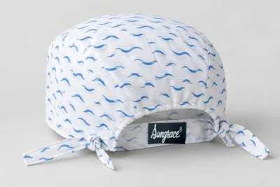 Scrub Caps — White woven scrub cap with original small blue abstract wave print and matching ties. product rear three-quarter. Illustrative catalogue concept.