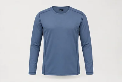 Underscrub Tops — Unisex steel-blue long-sleeve underscrub top with subtle navy coverstitch seam detail. product front. Illustrative catalogue concept.
